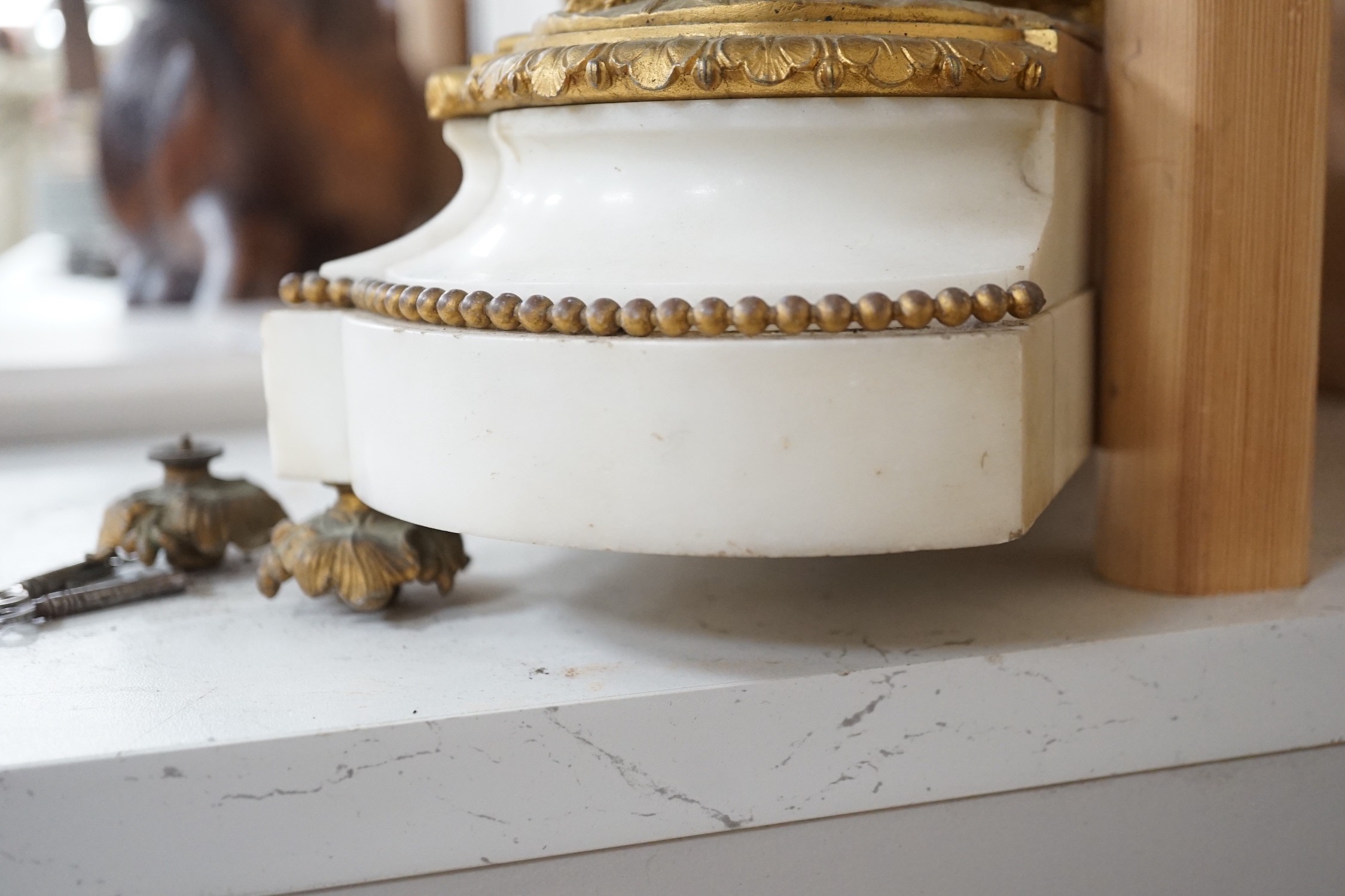 A 19th century French neoclassical revival figural ormolu and white marble clock, 39cm tall